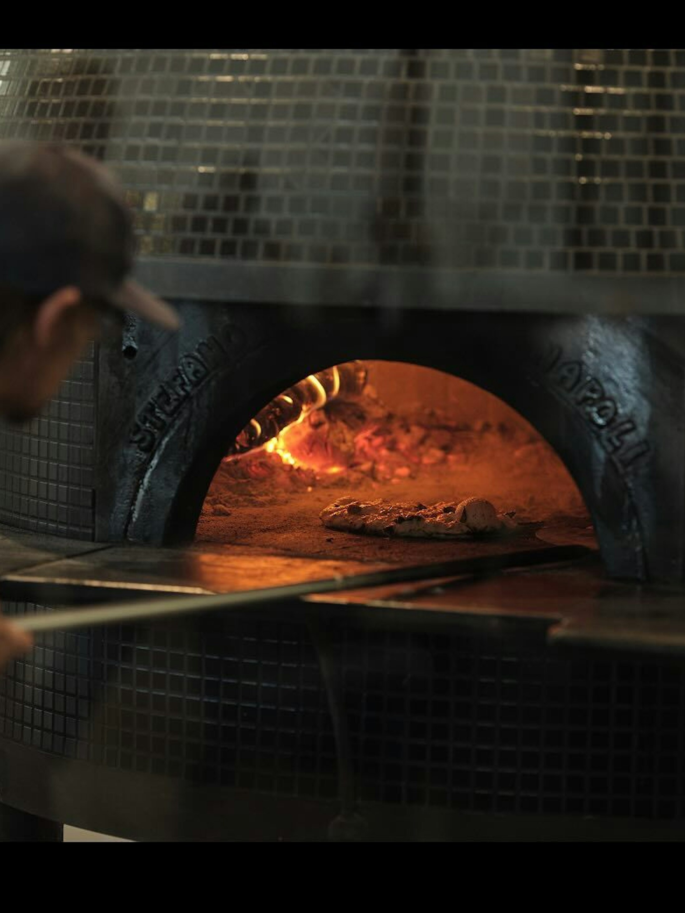 Turning pizza in wood fired oven